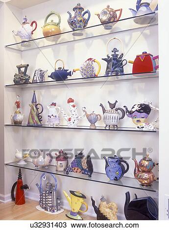 COLLECTION DISPLAYS - Recessed glass shelves used to display an art teapot collection of over 36 teapots all unique by various artist. Whimsical. View Large Photo Image Stock Image - COLLECTION DISPLAYS - Recessed glass shelves used to display an art teapot collection of over 36 teapots all unique by various artist. Whimsical. . Fotosearch