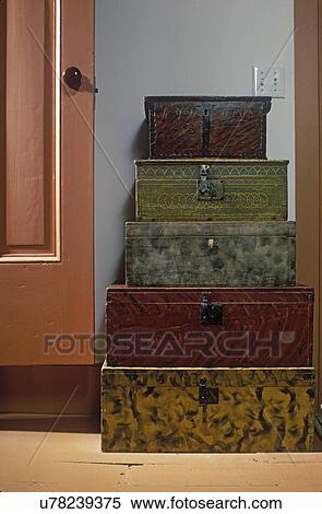 COLLECTION DISPLAYS: Stack of Early American antique wooden boxes with various paint finishes on floor. Door and blue wall as background. View Large Photo Image Stock Photography - COLLECTION DISPLAYS: Stack of Early American antique wooden boxes with various paint finishes on floor. Door and blue wall as background. . Fotosearch
