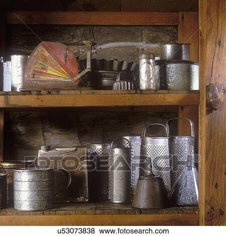 Stock Photo - COLLECTION DISPLAYS - Vintage kitchen implements range from egg grader to graters, oil cans, vintage tin ware, etc. . Fotosearch