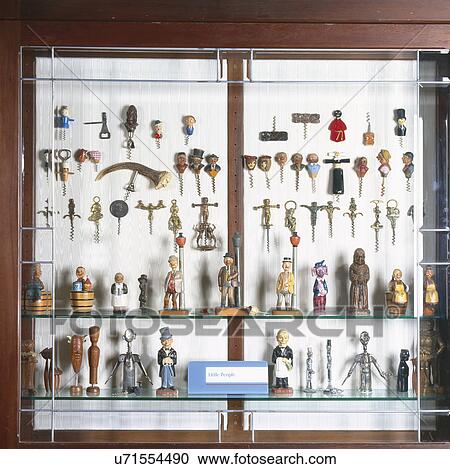 Stock Image - Collection of antique corkscrews on shelves and wall display. Fotosearch