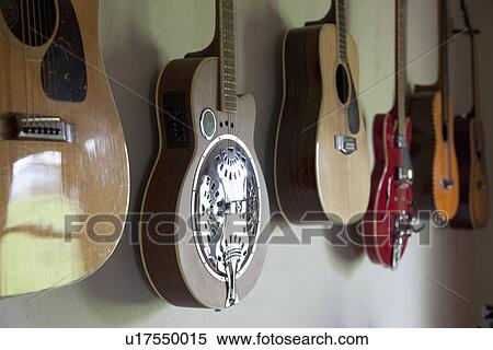 Collection of guitars hanging on wall; Porterville; California; USA View Large Photo Image Stock Photography - Collection of guitars hanging on wall; Porterville; California; USA. Fotosearch