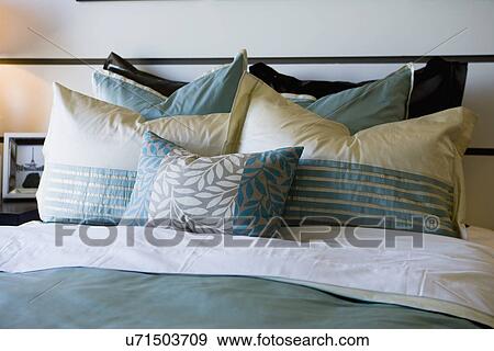 Stock Photo - Collection of pillows on bed; Oxnard; California; USA. Fotosearch