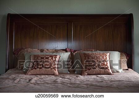 Collection of pillows on bed View Large Photo Image Stock Photo - Collection of pillows on bed. Fotosearch