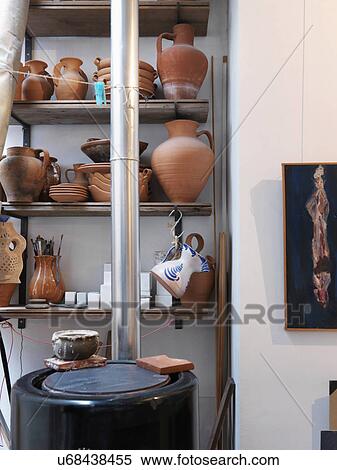 Stock Photography - Collection of terra cotta pots on shelves. Fotosearch