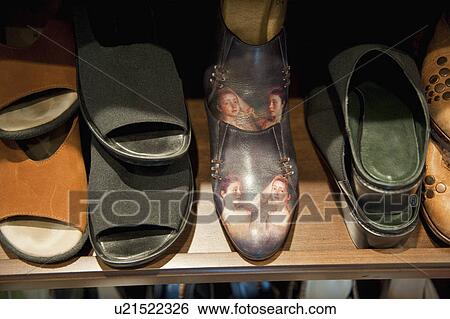 Stock Photograph - Collection of Woman's shoes on shelf; Irvine; California; USA. Fotosearch