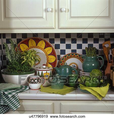 COLLECTIONS - DISHES: Italian design pottery, handmade in Bera KY. Various items, plates, bowls, pitcher, sugar, and creamer sit on a tile counter. View Large Photo Image Stock Photo - COLLECTIONS - DISHES: Italian design pottery, handmade in Bera KY. Various items, plates, bowls, pitcher, sugar, and creamer sit on a tile counter.. Fotosearch