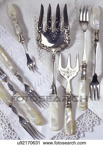 COLLECTIONS - Mother-of-pearl handles, sterling silver serving pieces on antique linens, iridescent, early 1900's. View Large Photo Image Stock Image - COLLECTIONS - Mother-of-pearl handles, sterling silver serving pieces on antique linens, iridescent, early 1900's.. Fotosearch