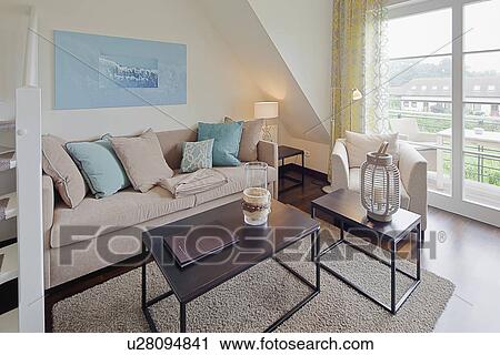 Stock Image - Comfortable sofa with coffee table on area rug in living room. Fotosearch