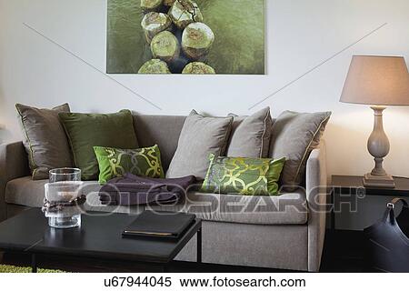 Comfortable sofa with cushions and table lamp in living room View Large Photo Image Stock Photography - Comfortable sofa with cushions and table lamp in living room. Fotosearch