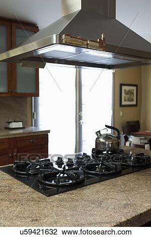 Stock Image - Cook top on kitchen island; Burbank; California; USA. Fotosearch