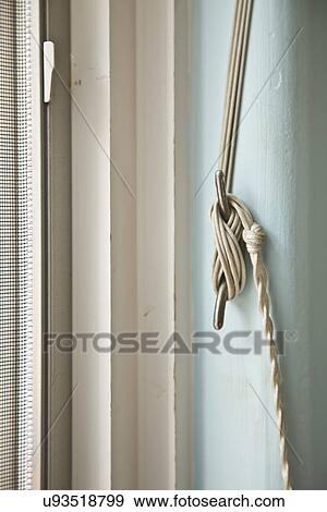 Cord from the blinds wrapped around hook; Carpinteria; California; USA View Large Photo Image Stock Photo - Cord from the blinds wrapped around hook; Carpinteria; California; USA. Fotosearch