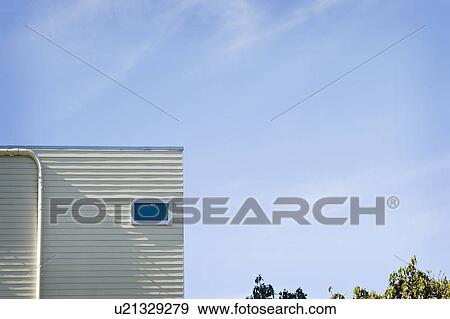 Stock Photo - Corner of home against blue sky, San Diego, California, USA. Fotosearch