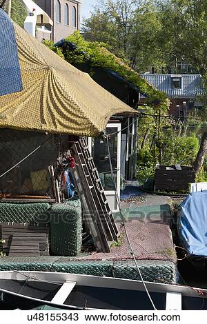 Cottage with commercial fishing nets flooring and roof View Large Photo Image Stock Image - Cottage with commercial fishing nets flooring and roof. Fotosearch