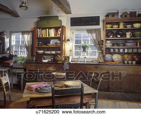 COUNTRY KITCHEN - Counter and sink area. Shelves, pottery. View Large Photo Image Stock Image - COUNTRY KITCHEN - Counter and sink area. Shelves, pottery. . Fotosearch