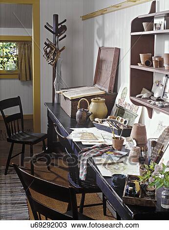 CRAFT/HOBBY ROOMS - Converted garage, long table against wall allow loads of room to create, watercolors on table, beadboard walls, wainscot, coat rack, flower pots on shelf, found objects View Large Photo Image Stock Image - CRAFT/HOBBY ROOMS - Converted garage, long table against wall allow loads of room to create, watercolors on table, beadboard walls, wainscot, coat rack, flower pots on shelf, found objects. Fotosearch