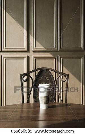 Cup of coffee on wooden dining table in front of chair; Ontario; California; USA View Large Photo Image Stock Photography - Cup of coffee on wooden dining table in front of chair; Ontario; California; USA. Fotosearch