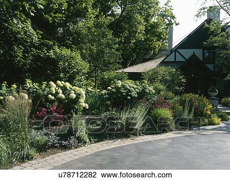Curved driveway along plants and bushes in garden View Large Photo Image Stock Image - Curved driveway along plants and bushes in garden. Fotosearch