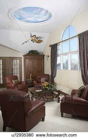 DAY SPA: Sitting area, leather club chairs, arched window with taffeta drapes, painted angel mural, armoire, cloud mural View Large Photo Image Stock Image - DAY SPA: Sitting area, leather club chairs, arched window with taffeta drapes, painted angel mural, armoire, cloud mural. Fotosearch