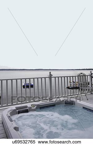 DECK: Overlooking Green Lake, Wi, hot tub on deck, white railings, metal patio chair View Large Photo Image Stock Photography - DECK: Overlooking Green Lake, Wi, hot tub on deck, white railings, metal patio chair. Fotosearch