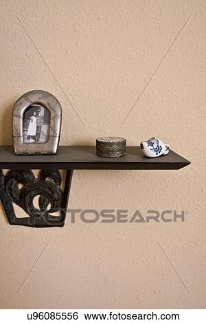 Stock Photograph - Decorations on shelf in home; Seal Beach; California; USA. Fotosearch
