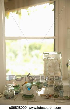 Stock Image - Decorative glass and shells on window ledge; Carpinteria; California; USA. Fotosearch