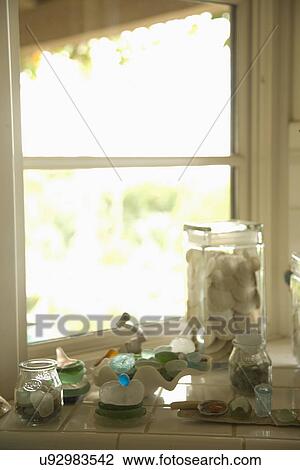 Stock Image - Decorative glass and shells on window ledge; Carpinteria; California; USA. Fotosearch