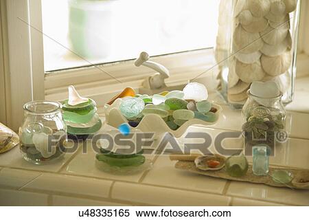 Stock Photography - Decorative glass and shells on window ledge; Carpinteria; California; USA. Fotosearch