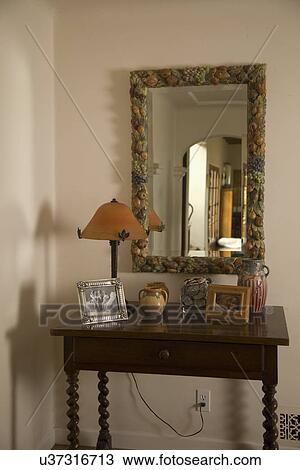 Stock Image - Decorative side board and mirror; Carpinteria; California; USA. Fotosearch