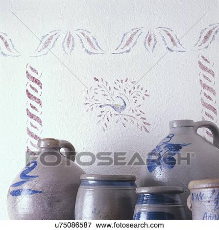 Stock Photo - Decorative urns and jars in front of designed wall. Fotosearch