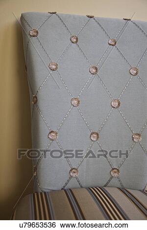 Stock Photograph - Detail blue chair back with buttons; Victorville; California; USA. Fotosearch