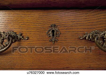 Stock Image - Detail key hole in wooden dresser drawer; Seal Beach; California; USA. Fotosearch