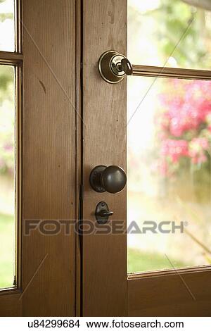 Picture - Detail keys and doorknob on wooden door; Carpinteria; California; USA. Fotosearch