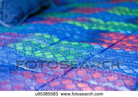 Stock Image - Detail of colorful comforter; Italy. Fotosearch