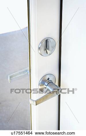 Picture - Detail of deadbolt and lever door handle. Fotosearch