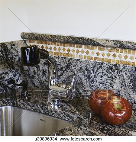 Detail of granite counter top, mosaic stone tile, steel utility inset sink, and two red apples View Large Photo Image Picture - Detail of granite counter top, mosaic stone tile, steel utility inset sink, and two red apples. Fotosearch