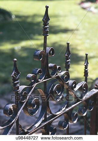 Detail of old black wrought iron gate in park View Large Photo Image Stock Photo - Detail of old black wrought iron gate in park. Fotosearch