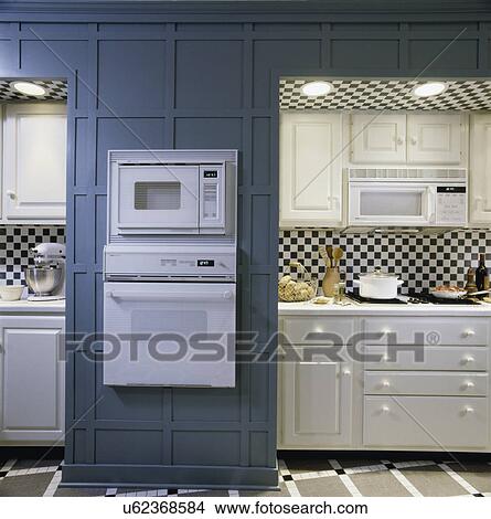 Detail of white cabinets with drawers, recessed lighting, oven, built- in appliances View Large Photo Image Picture - Detail of white cabinets with drawers, recessed lighting, oven, built- in appliances. Fotosearch