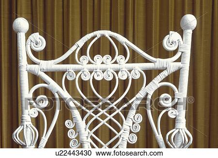 Detail of white wicker chair against brown curtain View Large Photo Image Stock Image - Detail of white wicker chair against brown curtain. Fotosearch