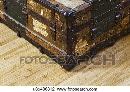 Stock Image - Detail old storage trunk on hardwood floor. Fotosearch