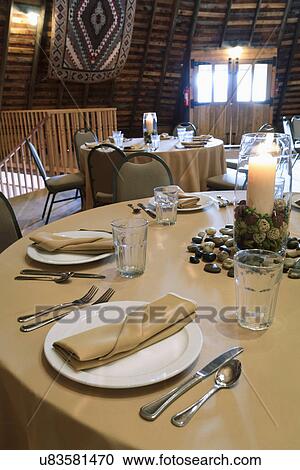 Stock Image - Detail place settings on circular dining table, Ojo Caliente, New Mexico, USA. Fotosearch