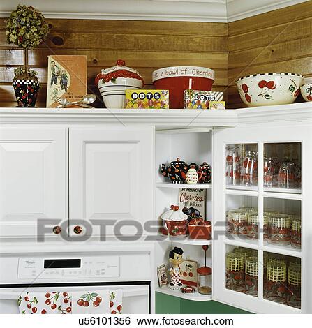 Detail shot, teapots, vintage glassware, bowls on wood white cabinets over counter in kitchen View Large Photo Image Stock Photograph - Detail shot, teapots, vintage glassware, bowls on wood white cabinets over counter in kitchen. Fotosearch
