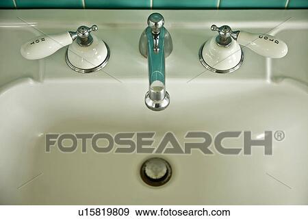 Stock Photo - Detail vintage sink with hot and cold faucet; Carpinteria; California; USA. Fotosearch