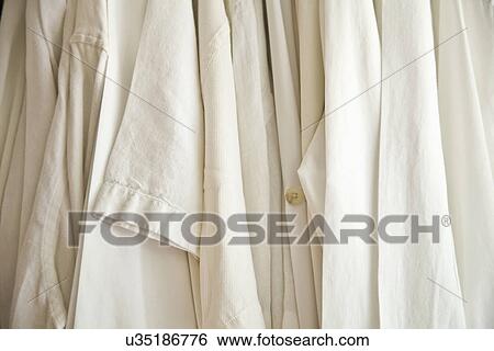 Stock Photograph - Detail white shirts hanging up; Carpinteria; California; USA. Fotosearch