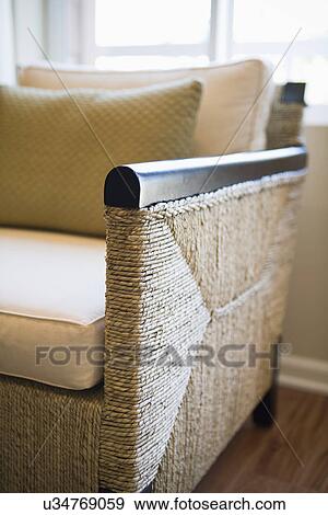 Stock Photo - Detail wicker armchair in front of window; Oxnard; California; USA. Fotosearch