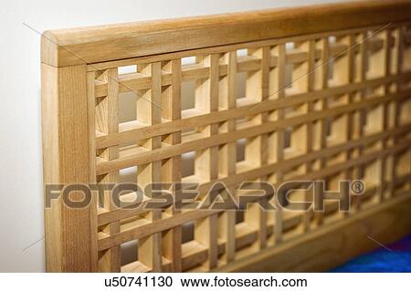 Stock Image - Detail wooden headboard; Italy. Fotosearch