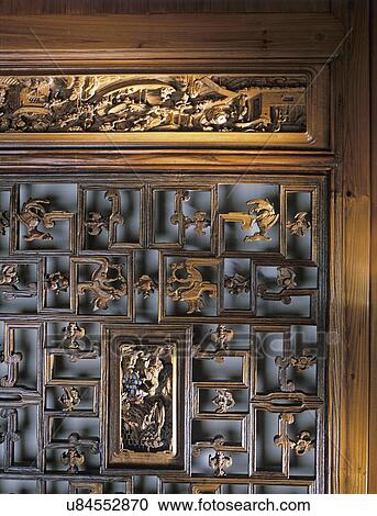 Stock Image - dining room: detail of carved wooden doors, Chinese. Fotosearch