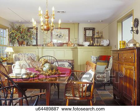Picture Of Dining Rooms Cherry Table Windsor Chairs Slate Picture Of Dining Rooms Cherry Table Windsor Chairs Slate Tile Flooring Mustard Colored Paneling Flank Fireplace Concealing Tv And Storage