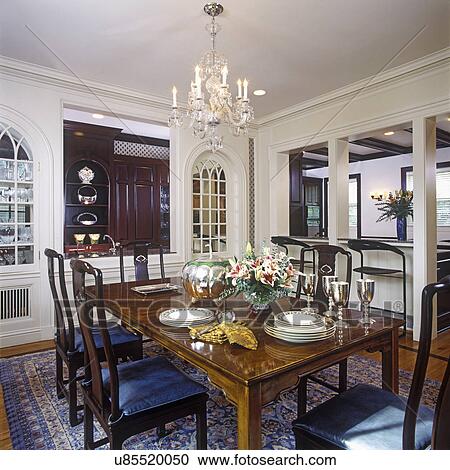 DINING ROOMS: Decorator Chinese style table and chairs, dishes stacked on table. Arch to kitchen, two windows on either side of opening to kitchen area, wet bar. View Large Photo Image Stock Image - DINING ROOMS: Decorator Chinese style table and chairs, dishes stacked on table. Arch to kitchen, two windows on either side of opening to kitchen area, wet bar.. Fotosearch