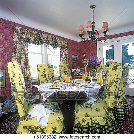 DINING ROOMS: Yellow slip covered chairs, patterned swag drapes, red patterned wallpaper, French doors, table set for breakfast, View Large Photo Image Stock Image - DINING ROOMS: Yellow slip covered chairs, patterned swag drapes, red patterned wallpaper, French doors, table set for breakfast,. Fotosearch