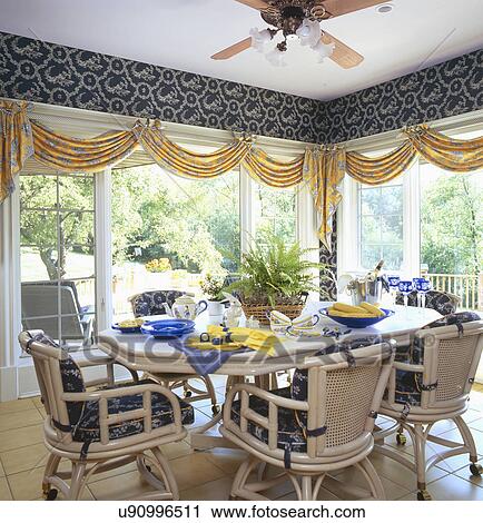 Dining table and chairs arranged in sunroom of traditional home View Large Photo Image Stock Image - Dining table and chairs arranged in sunroom of traditional home. Fotosearch